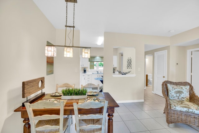 dining room featuring light tile patterned floors and baseboards