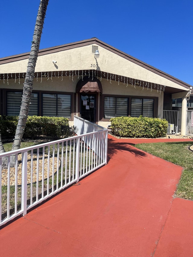 326 Knotty Pine Cir Unit C-2, Greenacres, FL 33463 - view of front of home with covered porch and stucco siding