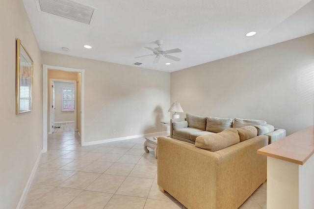 living area with light tile patterned floors, a ceiling fan, baseboards, and recessed lighting