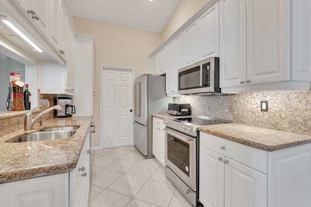 kitchen featuring appliances with stainless steel finishes, a sink, and white cabinetry