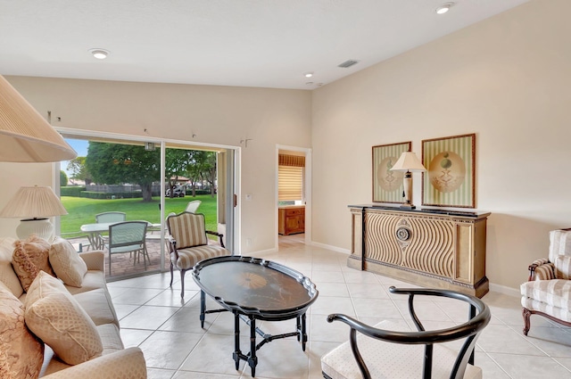 living area featuring light tile patterned floors, recessed lighting, baseboards, and lofted ceiling