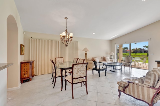 dining area featuring a chandelier, lofted ceiling, light tile patterned floors, and arched walkways