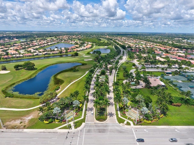 aerial view of residential area featuring a nearby body of water and a golf club
