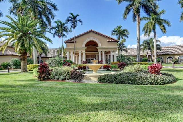 view of front facade with a front yard and stucco siding