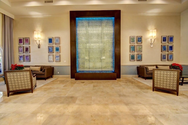 building lobby with crown molding and wainscoting