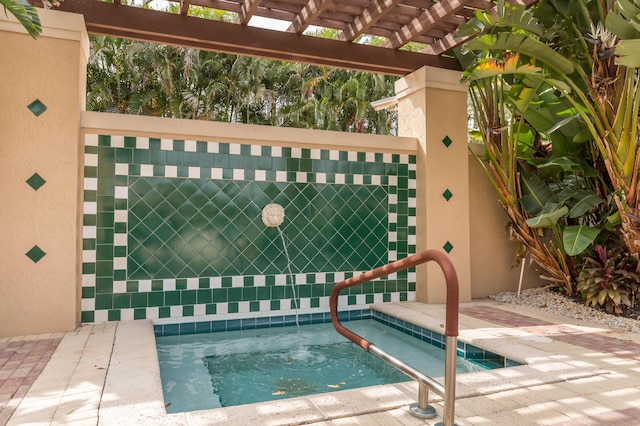 view of swimming pool featuring a pergola and an in-ground hot tub
