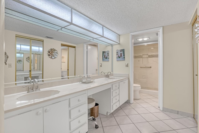 13446 Sabal Palm Ct Unit A, Delray Beach, FL 33484 - full bathroom featuring toilet, a stall shower, double vanity, tile patterned flooring, and a textured ceiling