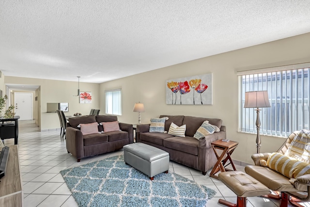 13446 Sabal Palm Ct Unit A, Delray Beach, FL 33484 - living area featuring light tile patterned floors, a textured ceiling, and baseboards