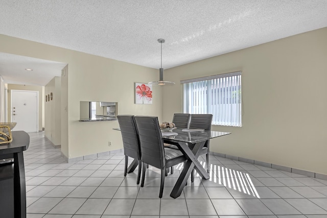 13446 Sabal Palm Ct Unit A, Delray Beach, FL 33484 - dining area featuring a textured ceiling, light tile patterned floors, and baseboards
