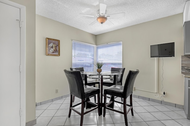 13446 Sabal Palm Ct Unit A, Delray Beach, FL 33484 - dining area featuring a textured ceiling, a ceiling fan, light tile patterned flooring, and baseboards