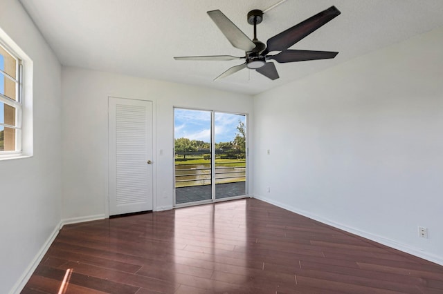 unfurnished room featuring wood finished floors, a ceiling fan, and baseboards