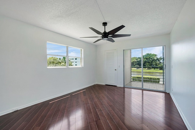unfurnished room featuring baseboards, a textured ceiling, wood finished floors, and ceiling fan