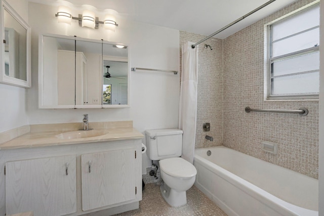 bathroom featuring toilet, a ceiling fan, shower / bath combo with shower curtain, and vanity