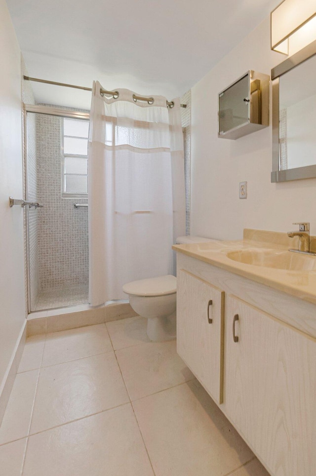 full bath with a stall shower, toilet, vanity, and tile patterned floors