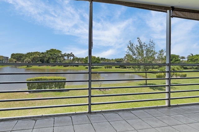 unfurnished sunroom featuring a water view