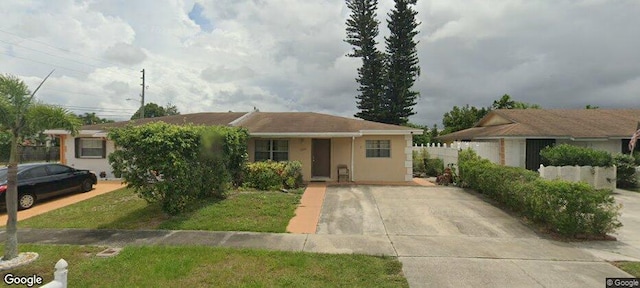 3762 Heather Dr W, Greenacres, FL 33463 - view of front of home with driveway, stucco siding, and fence