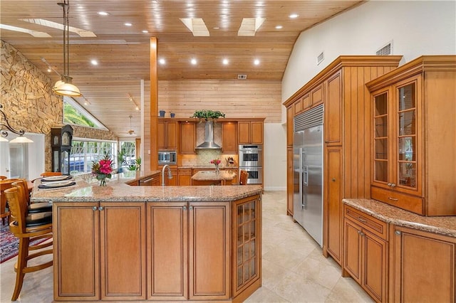 kitchen with wooden ceiling, built in appliances, high vaulted ceiling, a large island, and brown cabinetry