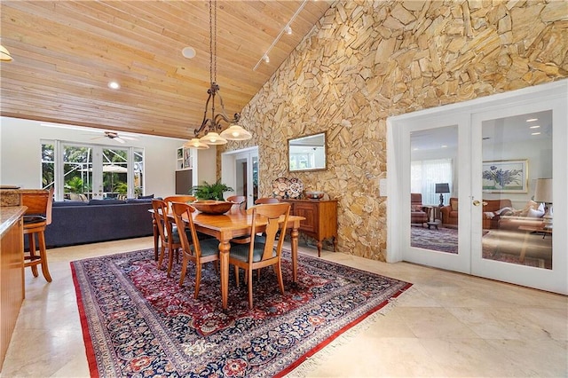 dining area featuring wood ceiling, high vaulted ceiling, french doors, a ceiling fan, and beam ceiling