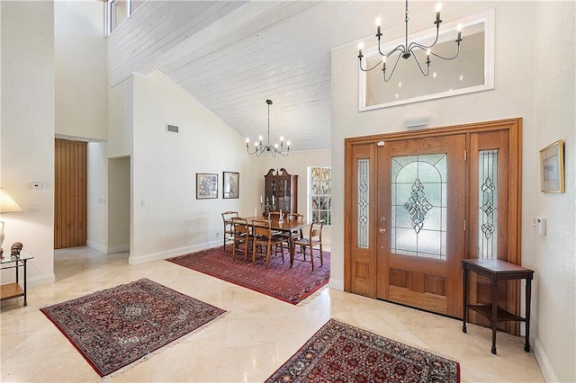 foyer entrance featuring a chandelier, high vaulted ceiling, baseboards, and beamed ceiling