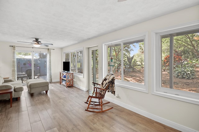 2414 SW Love Ct, Palm City, FL 34990 - sunroom with a textured ceiling, plenty of natural light, baseboards, and wood finished floors