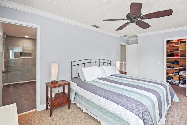 2414 SW Love Ct, Palm City, FL 34990 - bedroom featuring carpet floors, a walk in closet, a closet, a textured ceiling, and connected bathroom