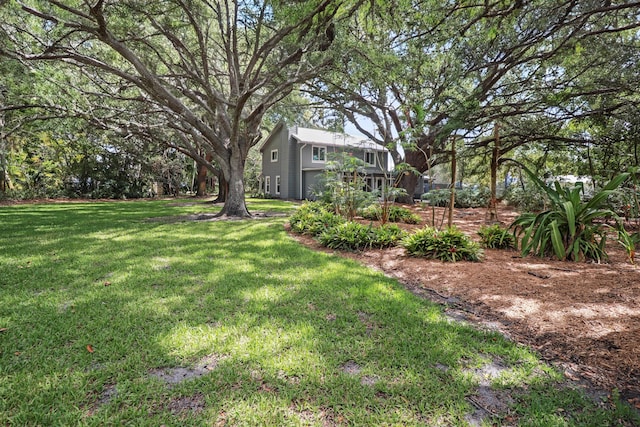 2414 SW Love Ct, Palm City, FL 34990 - view of green lawn featuring an attached garage