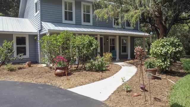 2414 SW Love Ct, Palm City, FL 34990 - view of front of house with covered porch and metal roof
