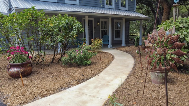 2414 SW Love Ct, Palm City, FL 34990 - property entrance featuring covered porch and metal roof