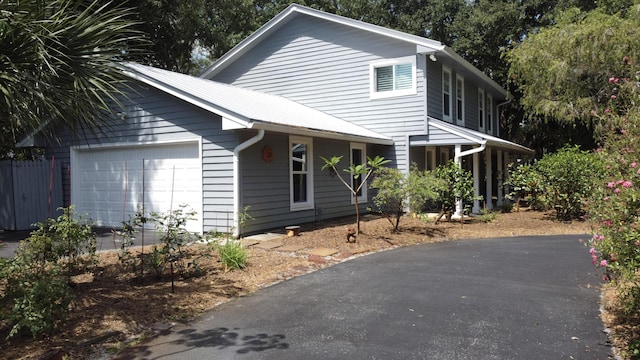 2414 SW Love Ct, Palm City, FL 34990 - view of front of property featuring a garage and asphalt driveway