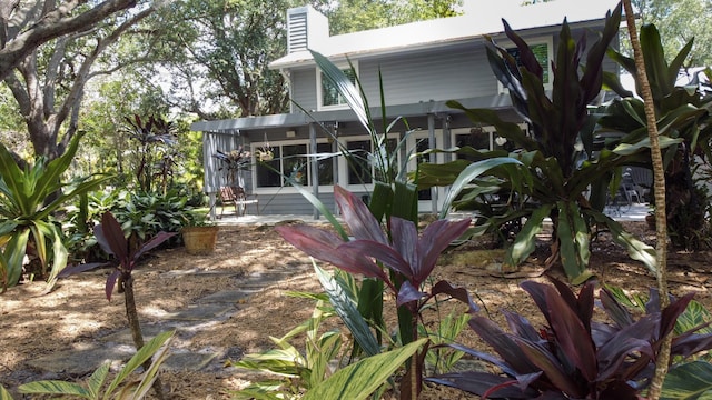 2414 SW Love Ct, Palm City, FL 34990 - back of house featuring a chimney