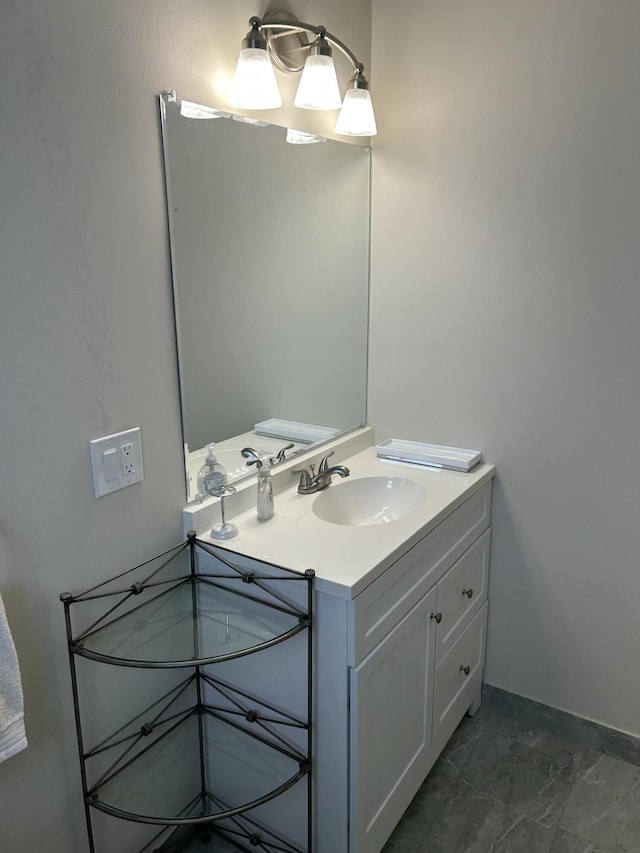 bathroom featuring vanity, marble finish floors, and baseboards