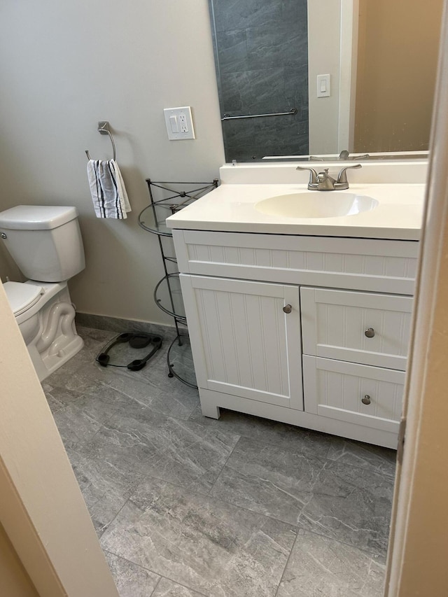 half bathroom with vanity and toilet