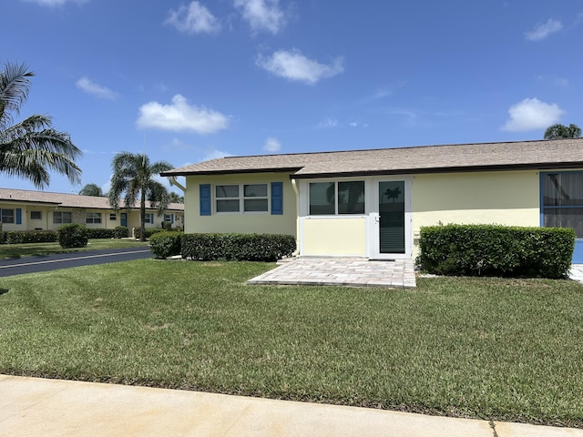 2844 E Crosley A Dr E Unit A, West Palm Beach, FL 33415 - view of front facade with a front lawn and stucco siding