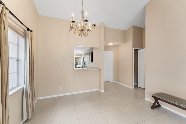 6616 Marissa Cir, Lake Worth, FL 33467 - unfurnished dining area featuring a chandelier, plenty of natural light, a high ceiling, baseboards, and light tile patterned floors