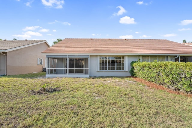 6616 Marissa Cir, Lake Worth, FL 33467 - back of house with stucco siding, a lawn, a sunroom, and a tiled roof