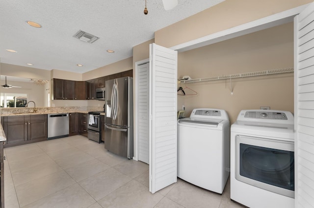 6616 Marissa Cir, Lake Worth, FL 33467 - laundry area featuring washing machine and clothes dryer, light tile patterned floors, ceiling fan, recessed lighting, and a textured ceiling