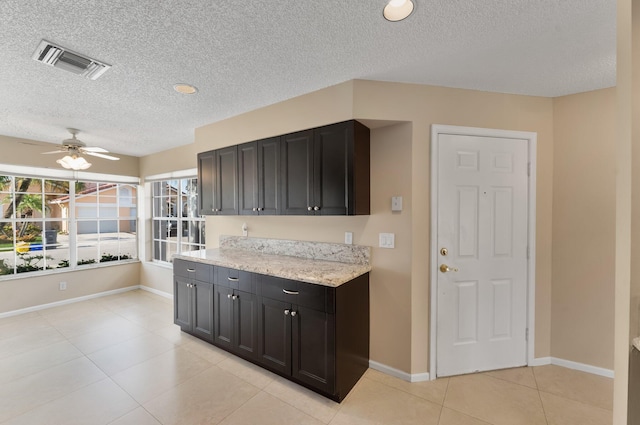 6616 Marissa Cir, Lake Worth, FL 33467 - kitchen featuring a textured ceiling, light tile patterned flooring, ceiling fan, and baseboards