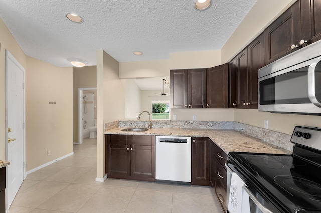 6616 Marissa Cir, Lake Worth, FL 33467 - kitchen with appliances with stainless steel finishes, a sink, dark brown cabinetry, a textured ceiling, and recessed lighting