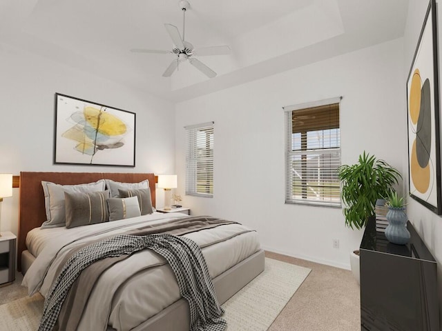 bedroom featuring light colored carpet, a ceiling fan, and baseboards