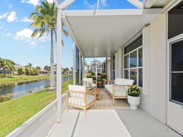 sunroom featuring a water view, an outdoor living space, and a residential view