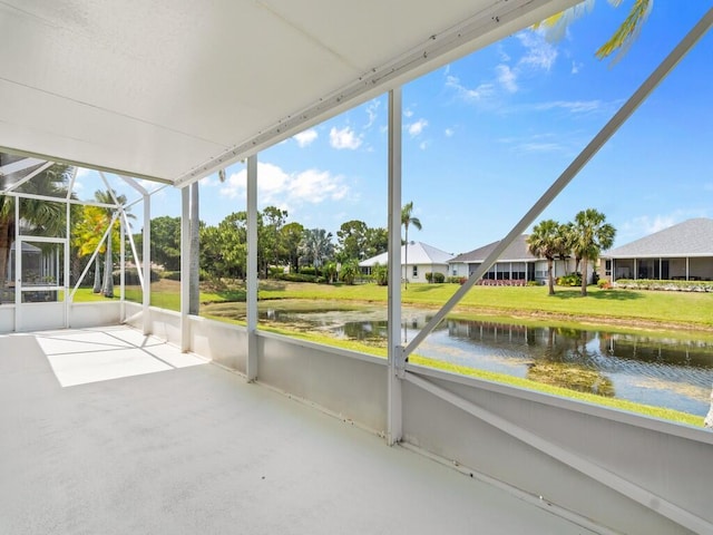 unfurnished sunroom featuring a water view
