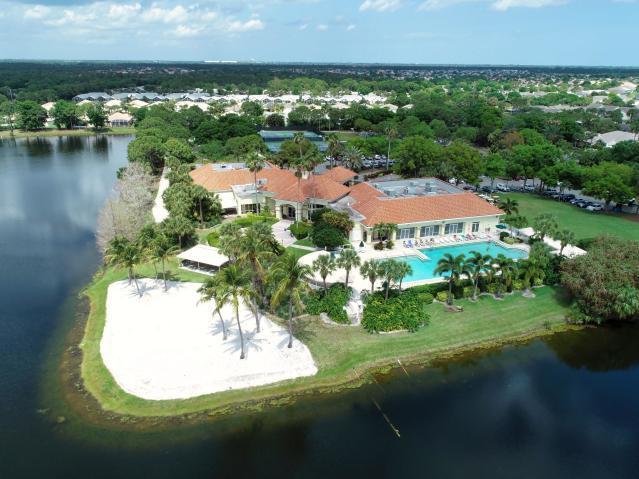 view of property location with a pool area and a nearby body of water