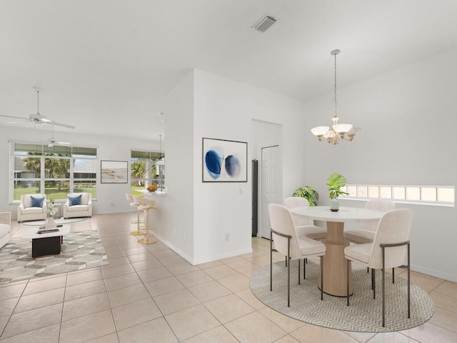 dining space with a chandelier, light tile patterned floors, a ceiling fan, and baseboards