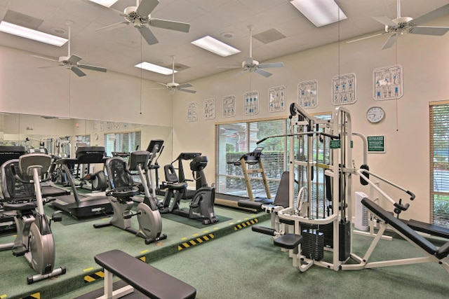 gym featuring a high ceiling and ceiling fan
