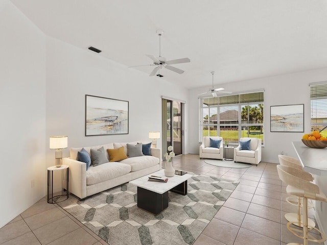 living area with light tile patterned floors and a ceiling fan