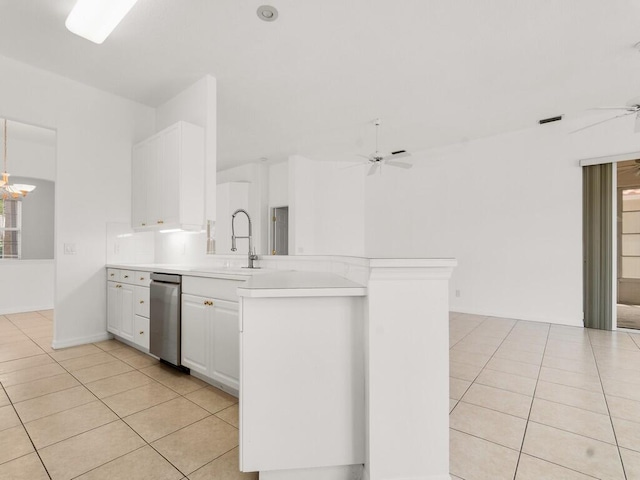 kitchen with dishwasher, light tile patterned floors, a ceiling fan, a sink, and a peninsula