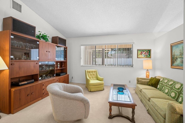 living room featuring carpet, a textured ceiling, lofted ceiling, and baseboards