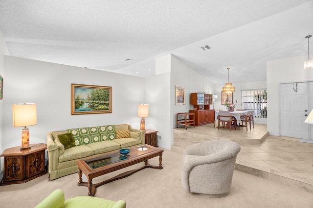 living area featuring a chandelier, lofted ceiling, light tile patterned floors, baseboards, and light carpet