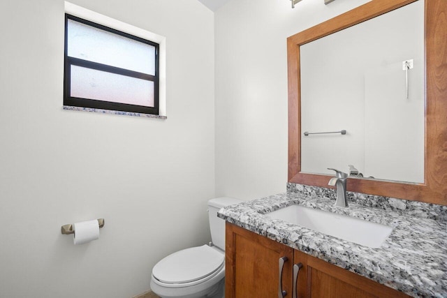 bathroom with toilet and vanity