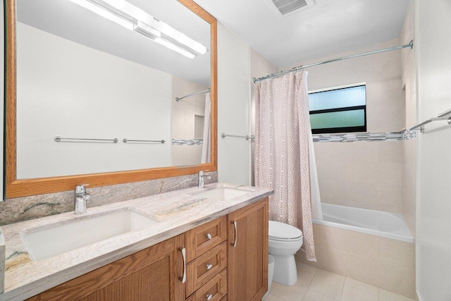 full bathroom featuring toilet, shower / bath combo, double vanity, and tile patterned floors